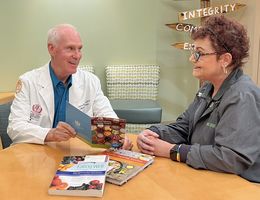 Andrew Woodward, MS, RD, CSO, an oncology nutritionist at Loma Linda University Cancer Center, speaks with a cancer survivor in the patient resource center.