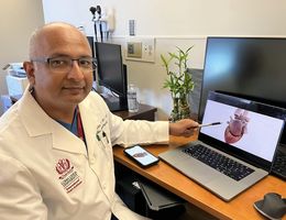 Kamal M. Kotak, MD, a cardiac electrophysiologist at Loma Linda University International Heart Institute, points to an interactive rendering of a human heart.