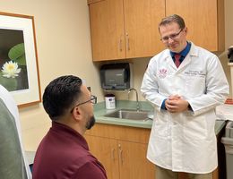 Medical oncologist Joel Brothers, MD, in his clinic at Loma Linda University Cancer Center where he consults with patients with prostate cancer about various treatment options.  