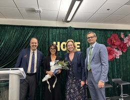Four people smile at the camera at the Seeds of Hope event