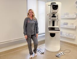 Heather Underwood, a mammography technician, stands next to a mammography machine at LLUH Women's Imaging Center.