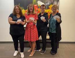 Loma Linda University Cancer Center team members hold up the gas cards they will be distributing to help support eligible patients in accessing critical cancer care. From left: Gina Morales, Judy Chatigny, Tamara Vasquez, Kristi Negrette