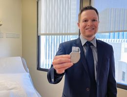 Brennan Rigby, MD, an electrophysiology fellow at Loma Linda University Medical Center, holds a defibrillator.