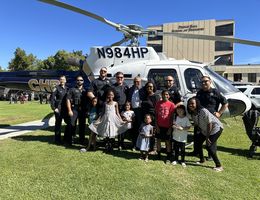 kids and law enforcement standing in front of helicopter