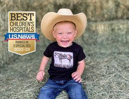 young smiling boy in cowboy hat