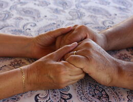 Couple holds hands