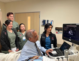 Dr. Ramesh Bansal performs an echocardiogram while International Heart Institute care team members observe.