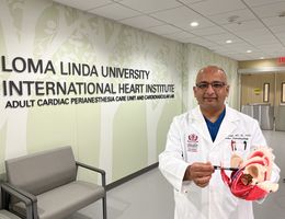 Dr. Kamal Kotak holds a three-dimensional model of a human heart.