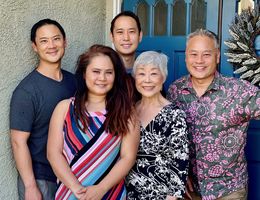Jean Hwang smiles, surrounded by her four children whose love and support helped her throughout her healing journey at Loma Linda University Cancer Center. Jean Hwang smiles, surrounded by her four children.