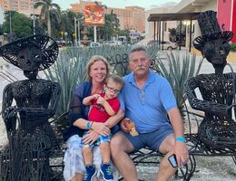 family sitting on a bench during vacation