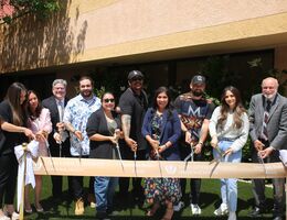 Mathews Bolden family cutting the ribbon in front of the courtyard