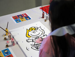 Girl painting mural of Sally Brown
