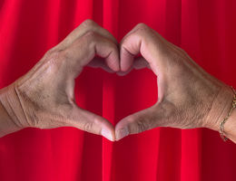 Woman makes heart shape with hands