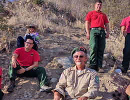 Surrounded by supportive Bear Divide Hotshots and his wife, Sharon, Loop Fire survivor Jerry Smith, center, returned to the site of the fatalities during a 50-year commemorative event Nov. 1 attended by hundreds of firefighters.