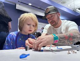 Boy and his dad play create robotic bug