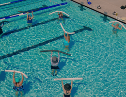 overhead shot of people doing water aerobics in a large pool
