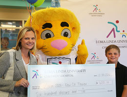 Max and Tammy Hilliard hold their check for Loma Linda University Children’s Hospital. 