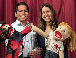 Marco Pasco-Rubio, a student in the School of Public Health and Ronda Spencer-Hwang, DrPH, display puppets they use as a part of their community health education efforts. lluh