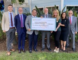 Hospital and government officials with large check 