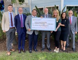 Hospital and government officials with large check 