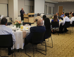 Ravvi Hillel Cohn addresses colleagues during an event honoring their work. He spoke on “Connecting Faith and Health.”