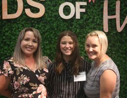 Grace posing with her mother and therapist at the 2022 Seeds of Hope fundraiser