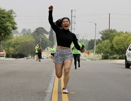 Woman celebrating at 5k finish line