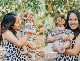 young mom smiling while holding four-month-old daughter