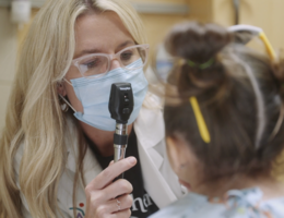 female doctor examines pediatric female patient