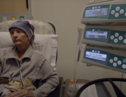 a woman sits in a chair while receiving a medical treatment 