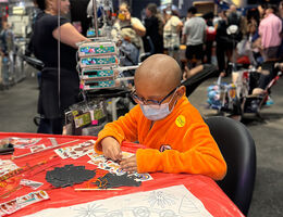 LLUCH pediatric male patient in Aang costume from avatar, sits at table and colors