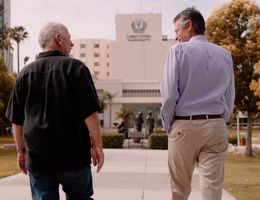 Thomas Hendrix and Dr. Herbert Ruckle talk and walk together on Loma Linda University's campus.