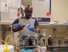 Thomas Hile, PhD, MSc, an LLU affiliated researcher, prepares water samples for testing in a laboratory.