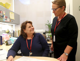 Candace Turner-Santacroce (left). manager of the Clinical Trials Unit at LLU Cancer Center, and Cyndee Pelton, clinical research coordinator, examine a patient chart.