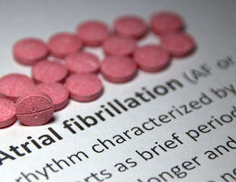 Red pills on piece of paper that says atrial fibrillliation
