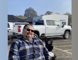 Armando Ortiz at a car show with his grandson