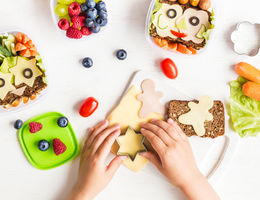 hands making school lunches