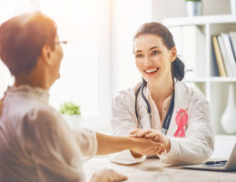 patient and doctor sit together