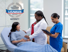 Pregnant woman in hospital room with doctor and nurse