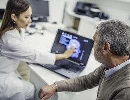 doctor shows patient brain scan