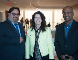 Three people standing together