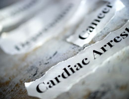 Pieces of paper on the table that say cardiac arrest and cancer