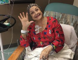 Michelle Arrigo smiles big as she holds up five fingers to signal her fifth of twelve rounds of infusion therapy at Loma Linda University Health – Beaumont – Banning in early 2020. Comprised of various therapies and a 14.5 hour surgery, Arrigo's arduous battle against pancreatic cancer ended in triumph when doctors declared she had No Evidence of Disease (NED).