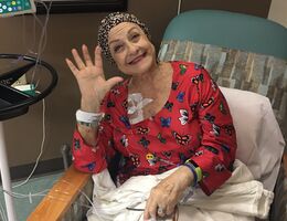 Michelle Arrigo smiles big as she holds up five fingers to signal her fifth of twelve rounds of infusion therapy at Loma Linda University Health – Beaumont – Banning in early 2020. Comprised of various therapies and a 14.5 hour surgery, Arrigo's arduous battle against pancreatic cancer ended in triumph when doctors declared she had No Evidence of Disease (NED).