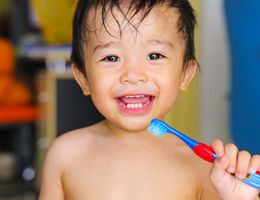 child holding tooth brush