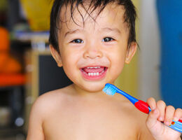 child holding tooth brush