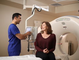 Patient speaking with provider before undergoing CT scan