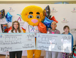 Andrea Rosenblatt (left) and Dawn Rashid presented their Birthday Club donation to LLUCH alongside Luke the Lion and LLUCH patient, Codi Pelton, 13, of Desert Hot Springs on Thursday, September 20.  