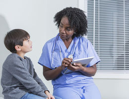 Doctor talking to child patient