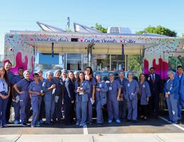 staff group photo in front of doughnut truck